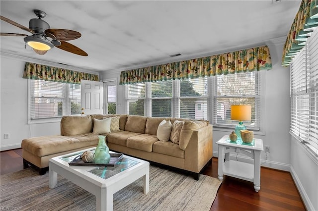 sunroom / solarium featuring a ceiling fan