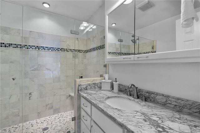 full bath with a stall shower and vanity