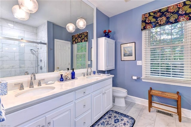 bathroom featuring visible vents, a sink, a shower stall, and double vanity