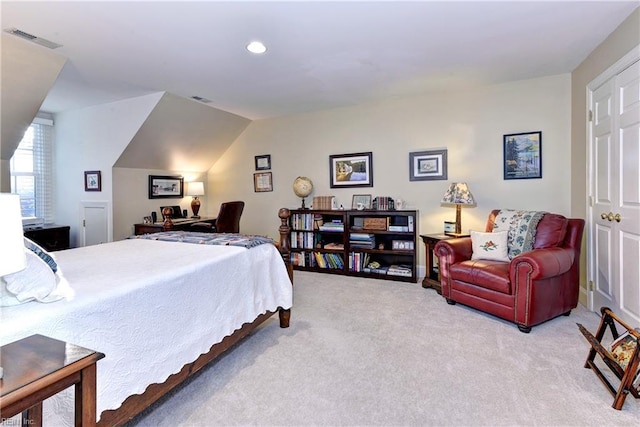 carpeted bedroom with lofted ceiling and visible vents