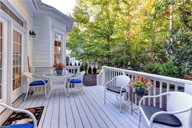 wooden terrace with outdoor dining area