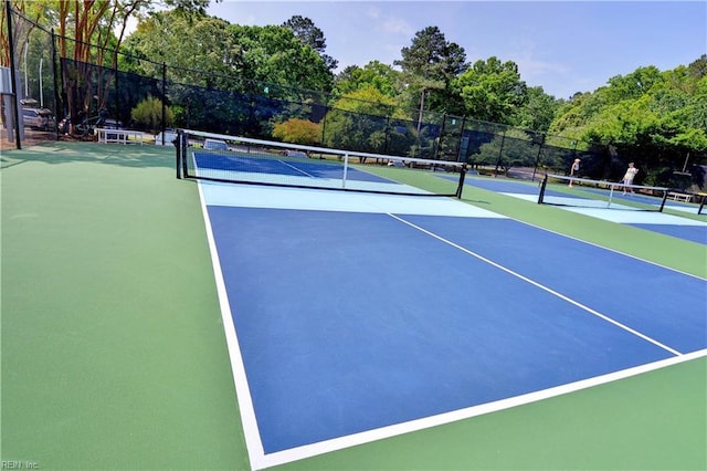 view of sport court featuring fence