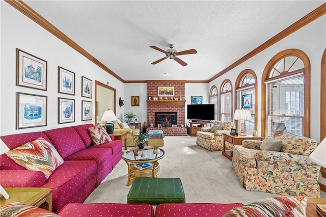 carpeted living room with crown molding, a fireplace, ceiling fan, and a textured ceiling