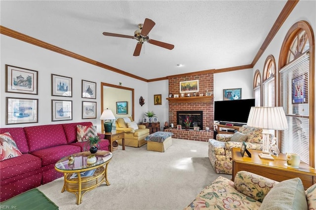 carpeted living area featuring ornamental molding, a fireplace, a textured ceiling, and a ceiling fan