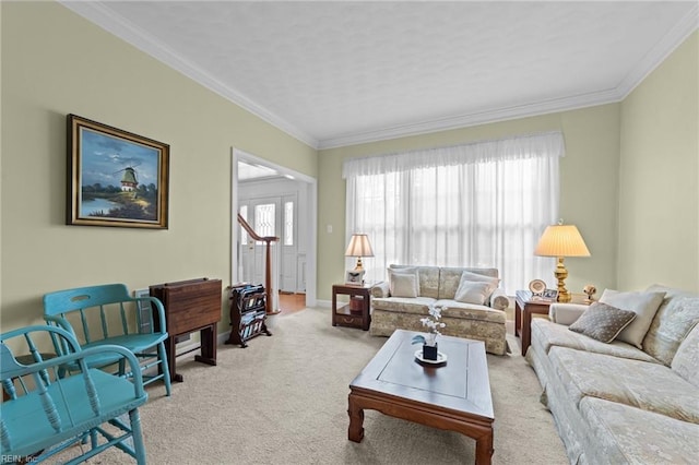 living area featuring baseboards, crown molding, and light colored carpet