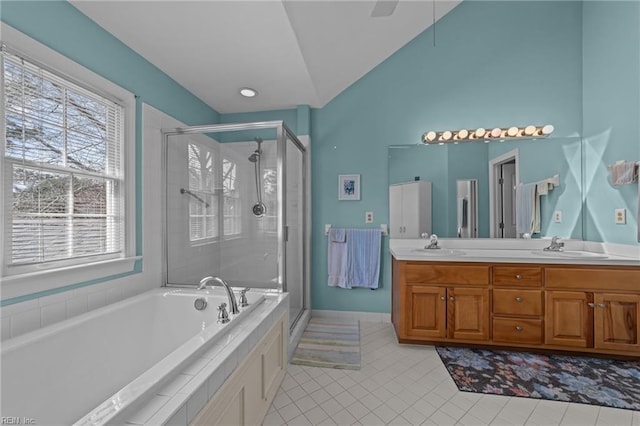 full bathroom featuring double vanity, vaulted ceiling, a shower stall, tile patterned flooring, and a bath