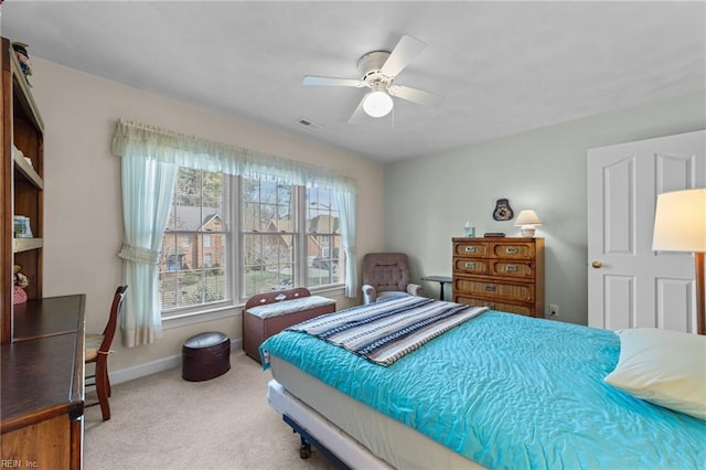 bedroom featuring carpet, visible vents, baseboards, and a ceiling fan