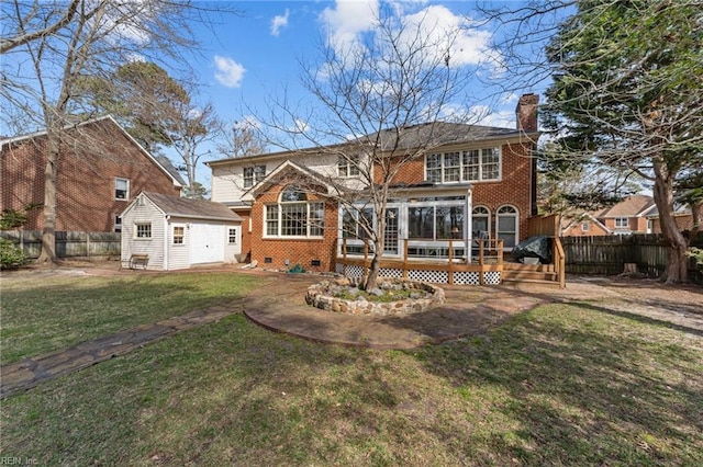 back of house with brick siding, a yard, a chimney, crawl space, and a fenced backyard