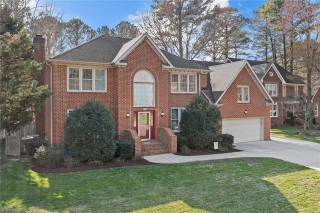 view of front of property with brick siding, a chimney, an attached garage, a front yard, and driveway