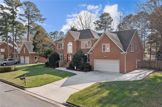 view of front of property featuring brick siding, an attached garage, a front yard, fence, and driveway