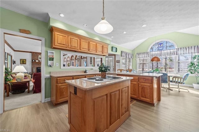 kitchen with lofted ceiling, a peninsula, a kitchen island, a brick fireplace, and white electric cooktop