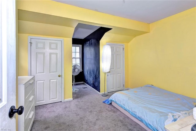 bedroom featuring carpet and baseboards