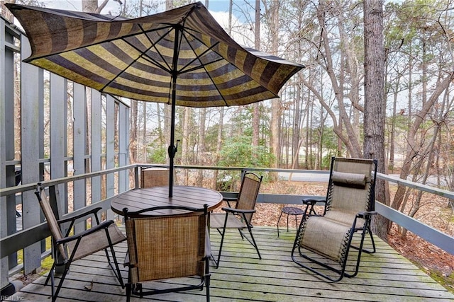 wooden terrace with outdoor dining space