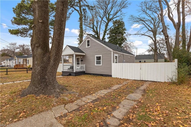 view of front of home with a porch, crawl space, and fence