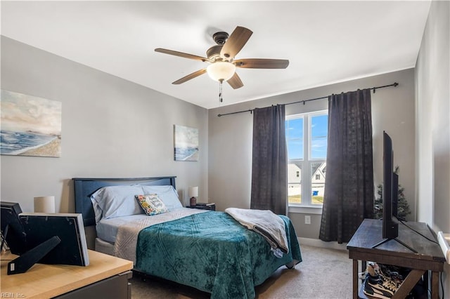 bedroom featuring carpet, baseboards, and a ceiling fan