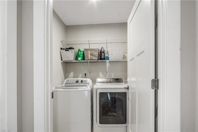 clothes washing area featuring washing machine and dryer and laundry area