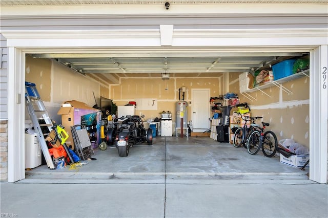 garage featuring a garage door opener and water heater