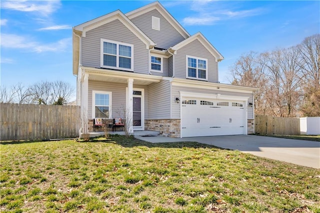 view of front of property featuring stone siding, a front yard, fence, and driveway