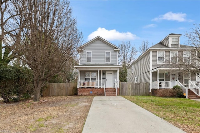 view of front of house with fence, a porch, and a front yard