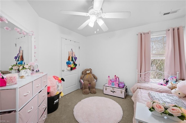 carpeted bedroom featuring ceiling fan and visible vents