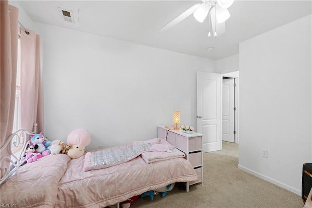 carpeted bedroom with ceiling fan, visible vents, and baseboards