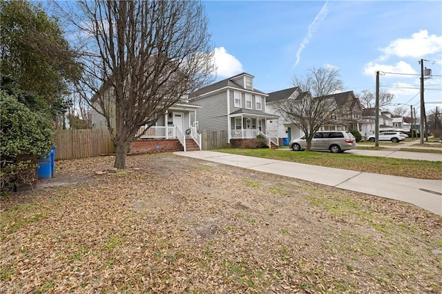 view of yard featuring driveway and fence