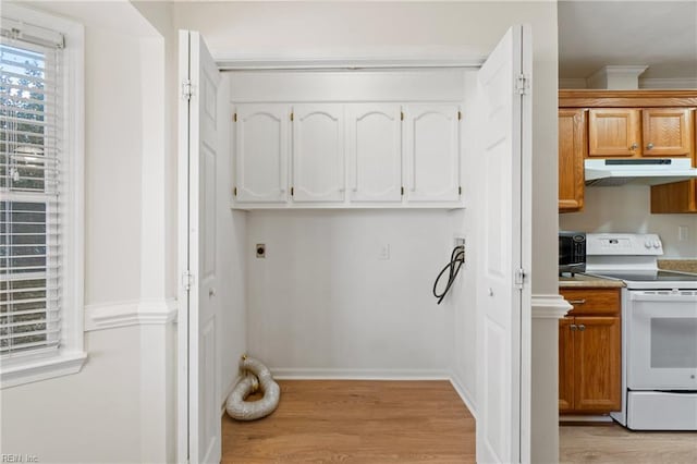 kitchen featuring under cabinet range hood, baseboards, white range with electric stovetop, brown cabinets, and light wood finished floors