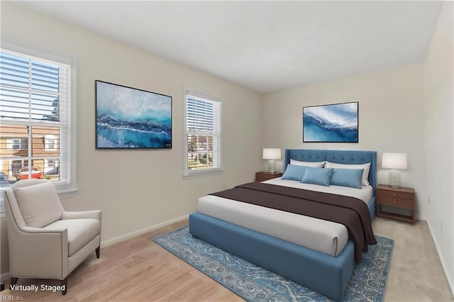 bedroom featuring light wood-style flooring and baseboards