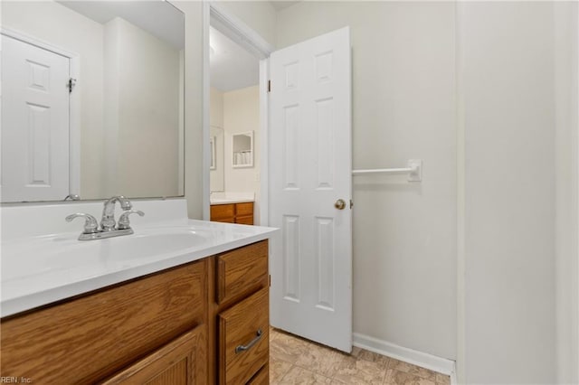 bathroom with vanity and baseboards