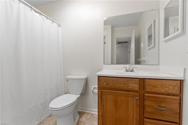 bathroom featuring visible vents, baseboards, vanity, and toilet