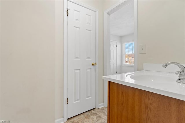 bathroom with baseboards and vanity