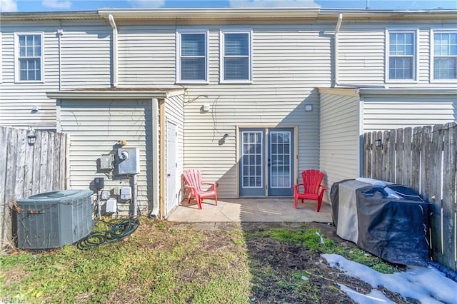 back of property featuring central AC, a patio area, and a fenced backyard