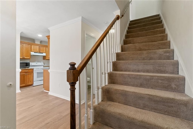 stairs featuring baseboards, wood finished floors, and recessed lighting