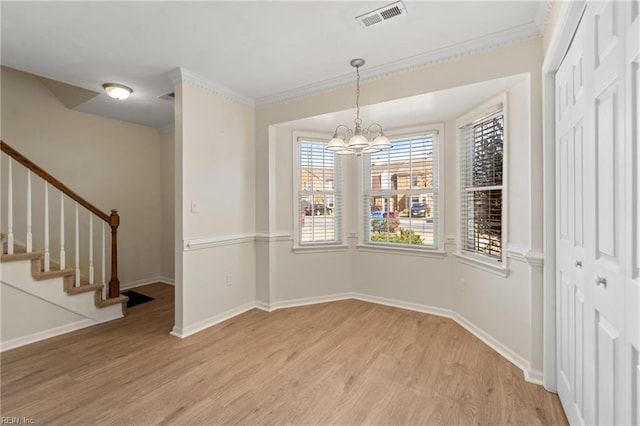 unfurnished dining area with light wood finished floors, stairway, visible vents, and baseboards