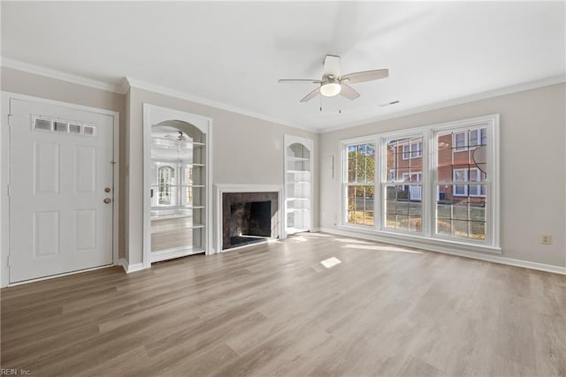 unfurnished living room with a ceiling fan, a fireplace, and wood finished floors