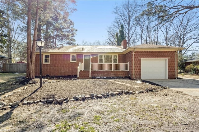 ranch-style house featuring driveway, a chimney, crawl space, an attached garage, and brick siding