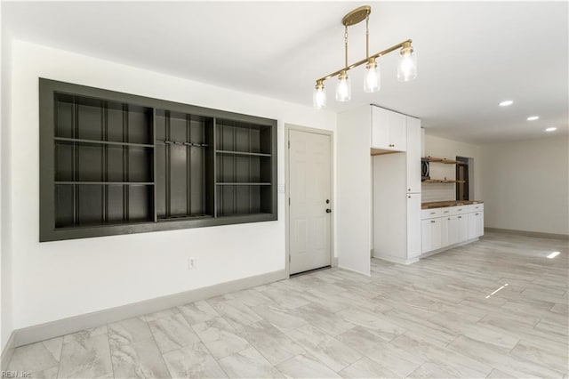 interior space featuring recessed lighting and baseboards