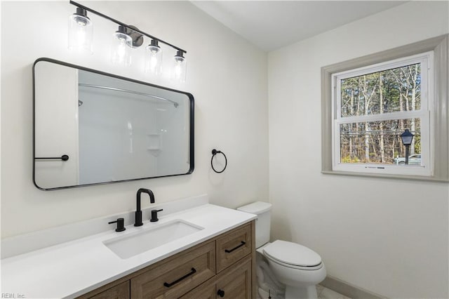 bathroom featuring toilet and vanity