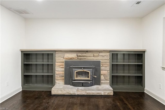 room details featuring visible vents, baseboards, and wood finished floors