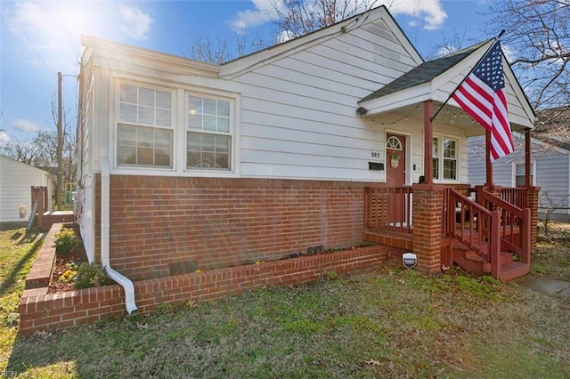 view of front of property with a front yard and brick siding