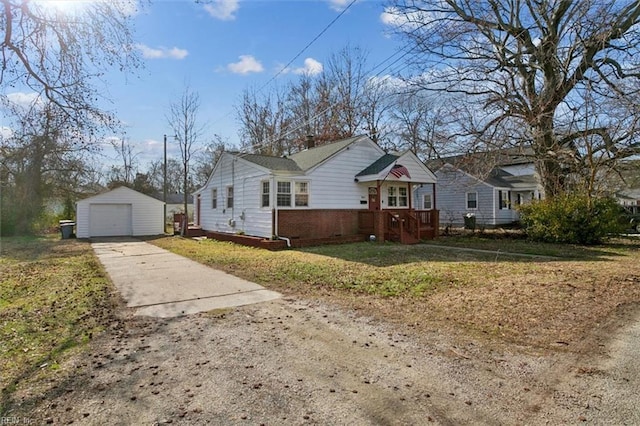 view of front of house featuring a garage, brick siding, an outdoor structure, concrete driveway, and a front yard