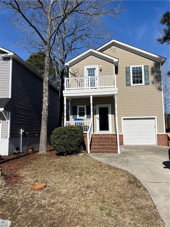 view of front of house with a porch, a balcony, an attached garage, and driveway