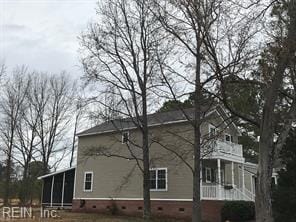 view of side of property with a sunroom