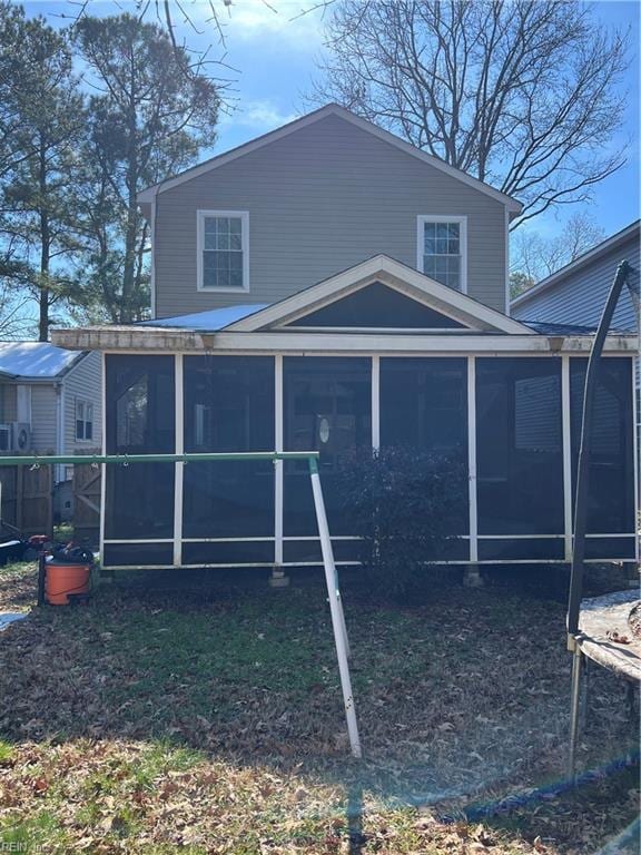 back of house featuring a sunroom