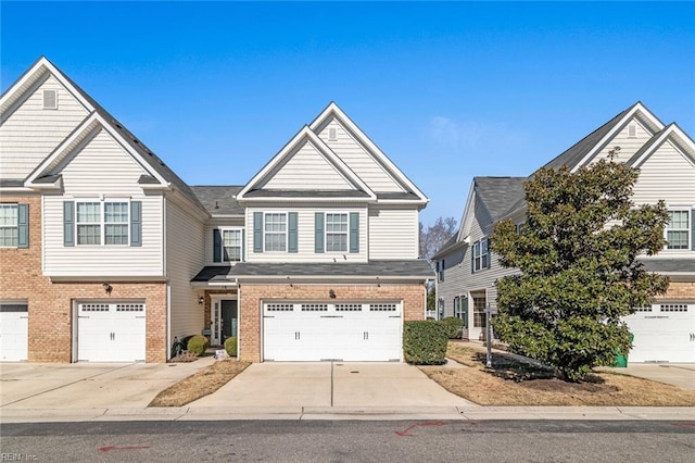 view of front of property featuring driveway, brick siding, and an attached garage