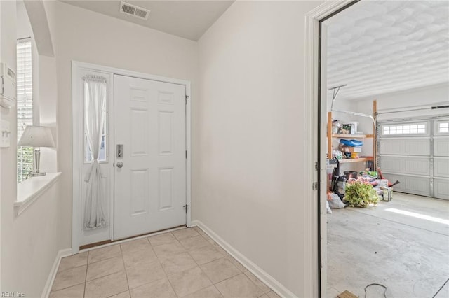 entryway featuring visible vents, baseboards, and light tile patterned floors