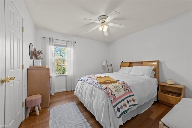 bedroom featuring dark wood-style floors and ceiling fan