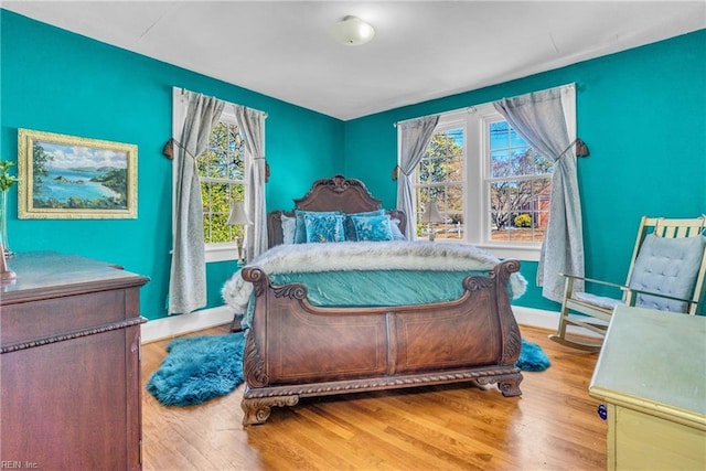 bedroom featuring baseboards and wood finished floors