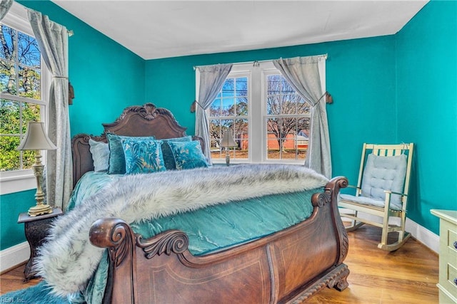 bedroom featuring baseboards and wood finished floors