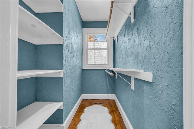 walk in closet featuring wood finished floors